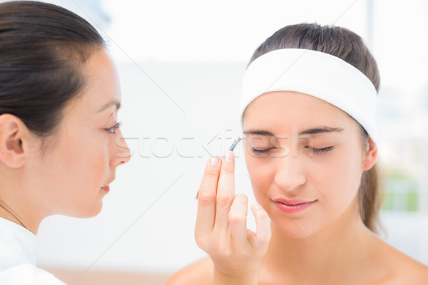 Hand applying eyeshadow to beautiful woman Stock photo © wavebreak_media