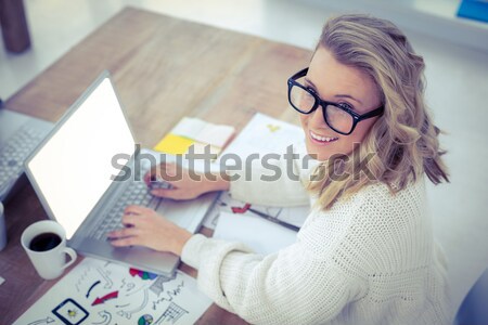 Digital composite image of woman using tablet PC with icons in foreground Stock photo © wavebreak_media