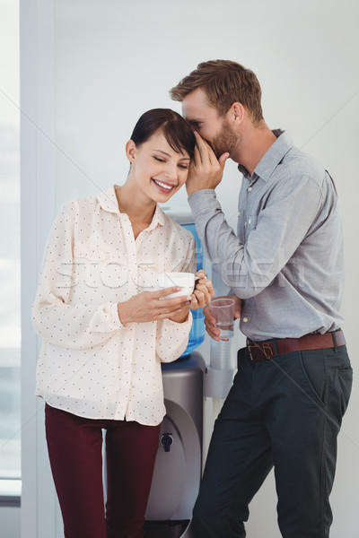 Man whispering in his colleagues ear Stock photo © wavebreak_media