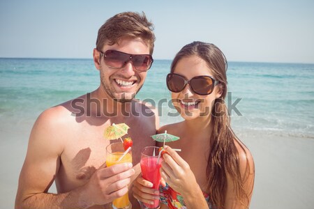 Stock photo: Portrait of happy couple holding drinks at beach