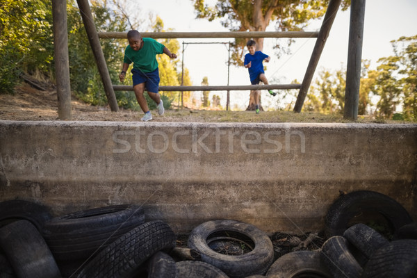 Boys exercising on outdoor equipment during obstacle course Stock photo © wavebreak_media