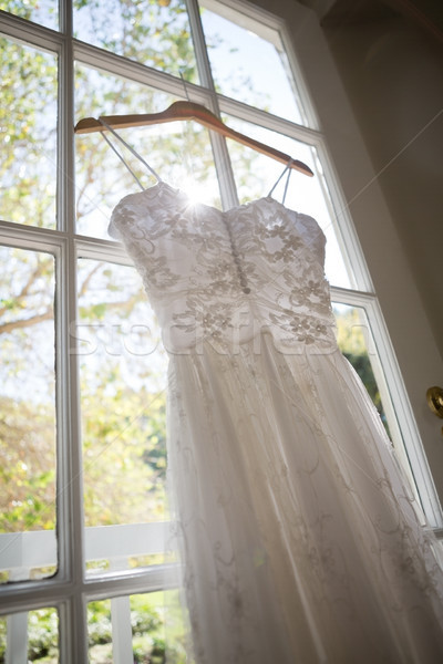 Low angle view of wedding dress hanging on window Stock photo © wavebreak_media