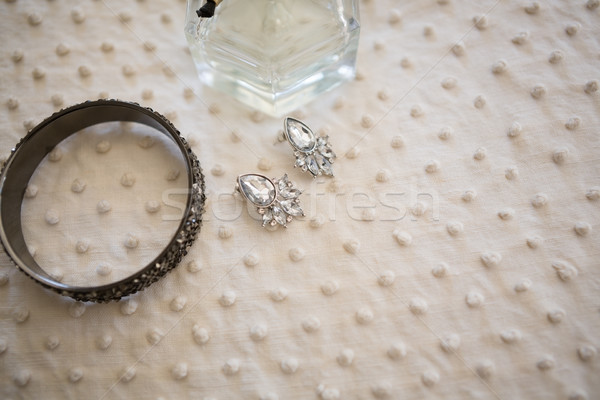 Close up of earring with bangle and perfume bottle in dressing room Stock photo © wavebreak_media