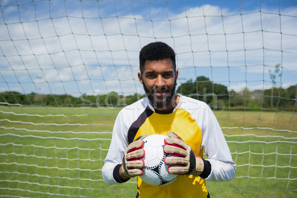 Goalkeeper with ball standing in front of goal post Stock photo © wavebreak_media