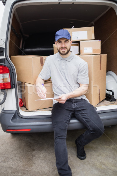 Delivery man writing on clipboard Stock photo © wavebreak_media