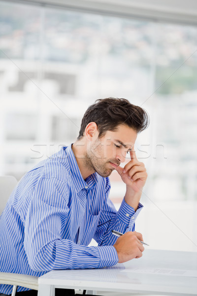 Businessman writing on paper Stock photo © wavebreak_media