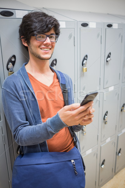 Portrait souriant étudiant téléphone portable vestiaire permanent [[stock_photo]] © wavebreak_media