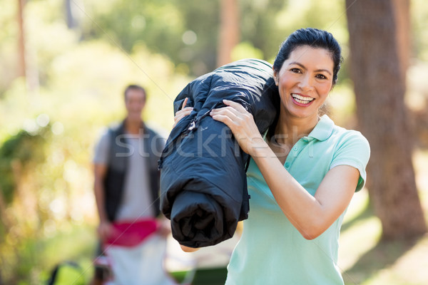 Woman smiling and holding a sleeping bag Stock photo © wavebreak_media
