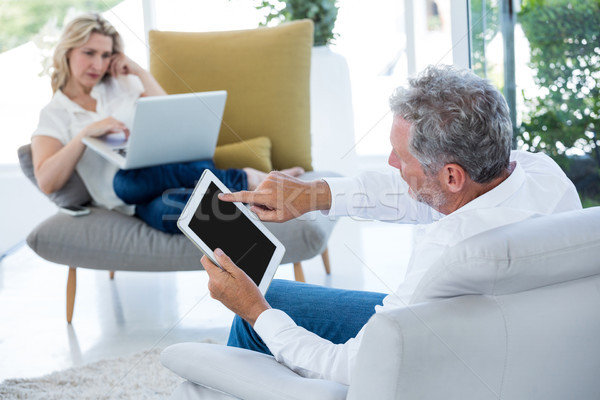 Man using tablet while woman holding laptop Stock photo © wavebreak_media