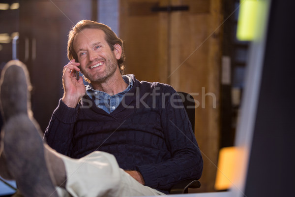 Businessman smiling while talking on cellphone Stock photo © wavebreak_media