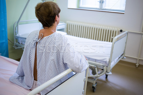 Rear view of sad senior patient sitting on a bed Stock photo © wavebreak_media