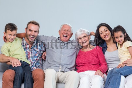 Family watching television while sitting on sofa Stock photo © wavebreak_media