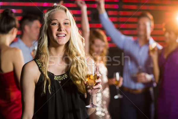 Portrait of young woman holding a glass of champagne Stock photo © wavebreak_media