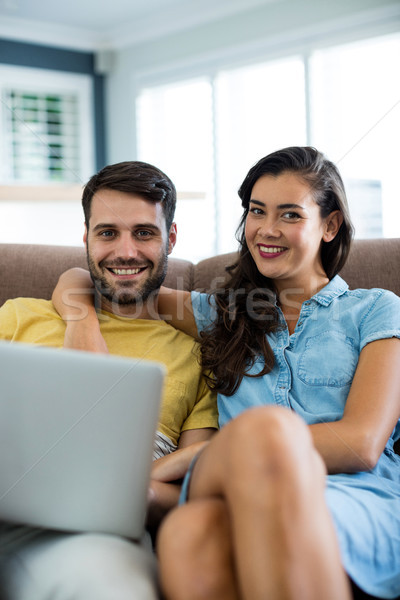 Portrait of smiling couple with laptop in the living room Stock photo © wavebreak_media