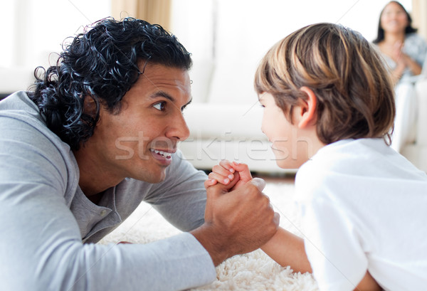 Cute little boy and his father armwrestling Stock photo © wavebreak_media