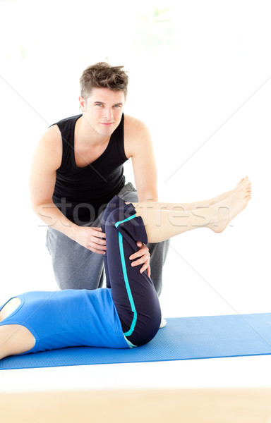 A woman exercising assited by her personal trainer Stock photo © wavebreak_media