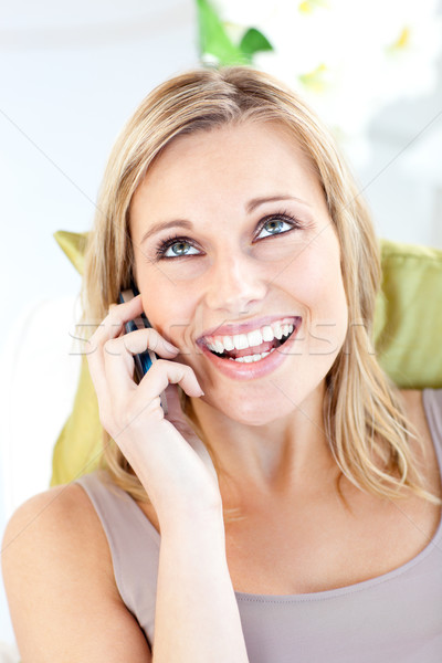 Animated caucasian woman talking on phone in the living room Stock photo © wavebreak_media