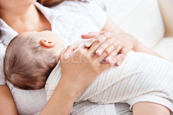 Delighted young mother taking care of her adorable baby at home Stock photo © wavebreak_media