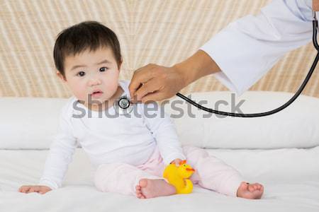 Adorable baby taking a bath wihile his adorable mother takes care of him at home Stock photo © wavebreak_media