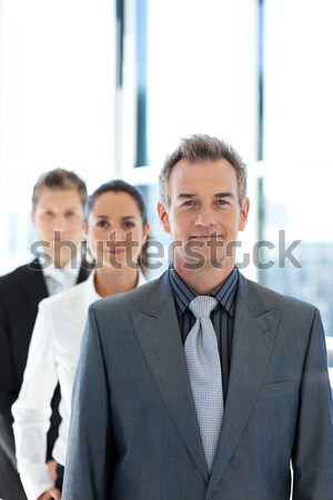 Three happy business people posing in a row in the office Stock photo © wavebreak_media