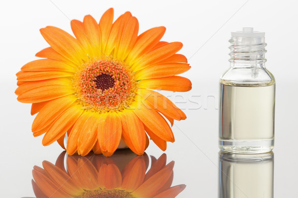 A glass phial and an orange gerbera against a white white background Stock photo © wavebreak_media
