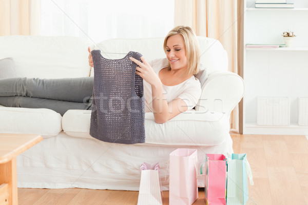 Woman looking at the clothes she bought in her living room Stock photo © wavebreak_media