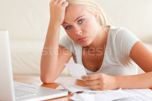 Stock photo: Worried woman accounting looking into the camera in the living room