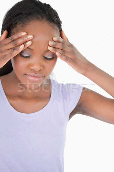 Close up of young woman experiencing a headache on white background Stock photo © wavebreak_media