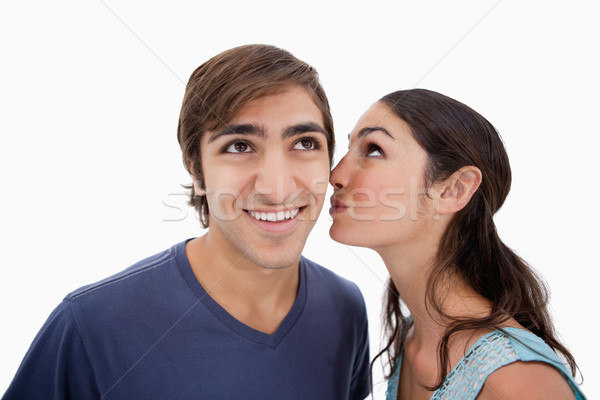 Lovely woman whispering something to her fiance against a white background Stock photo © wavebreak_media