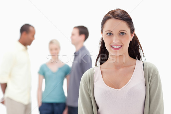 Close-up of a woman smiling with friends chatting in background Stock photo © wavebreak_media