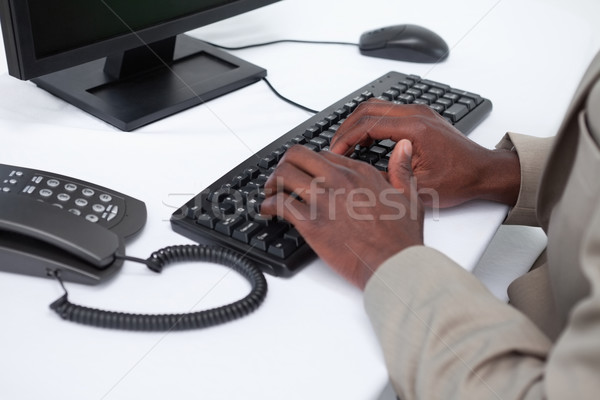 Close up of masculine hands typing with a keyboard against a white background Stock photo © wavebreak_media