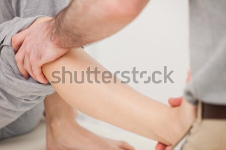 Doctor using his finger to massaged the back of his patient in a room Stock photo © wavebreak_media