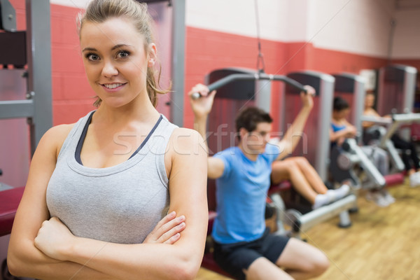Smiling female trainer with arms crossed in fitness studio in gym Stock photo © wavebreak_media