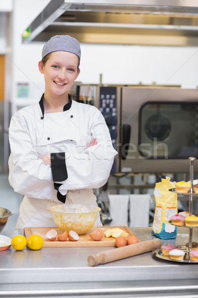 Smiling pastry chef standing behind counter in kitchen Stock photo © wavebreak_media
