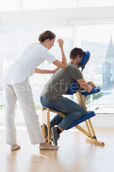 Female therapist giving back massage to man Stock photo © wavebreak_media