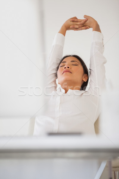 Stock photo: Casual businesswoman napping at her desk