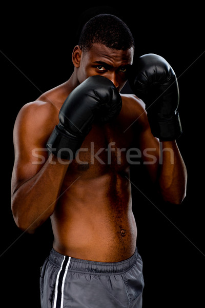Portrait of a shirtless muscular boxer in defensive stance Stock photo © wavebreak_media