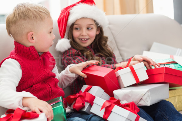 Festive siblings surrounded by gifts Stock photo © wavebreak_media