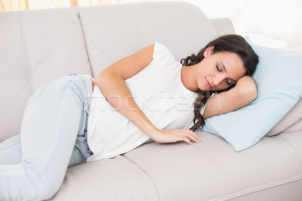 Pretty brunette napping on couch Stock photo © wavebreak_media