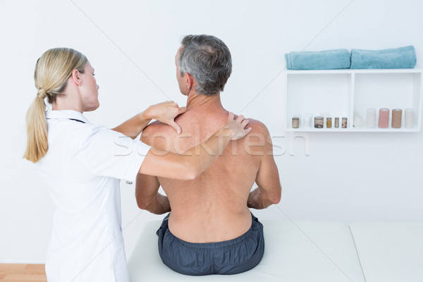 Doctor examining her patient back  Stock photo © wavebreak_media