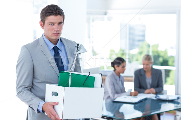 Businessman carrying his belongings in box Stock photo © wavebreak_media