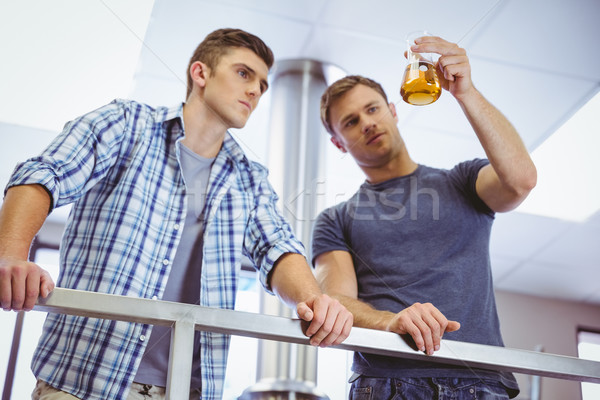Men holding beaker with beer Stock photo © wavebreak_media