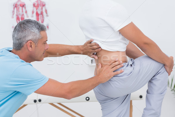 Doctor examining his patient back  Stock photo © wavebreak_media