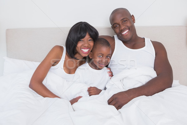 Pretty couple with his son in bed together Stock photo © wavebreak_media