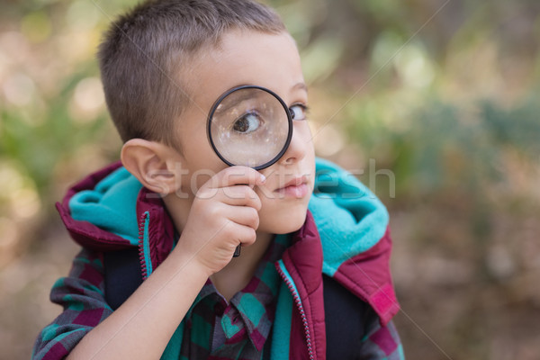 Little boy looking through magnifying glass Stock photo © wavebreak_media