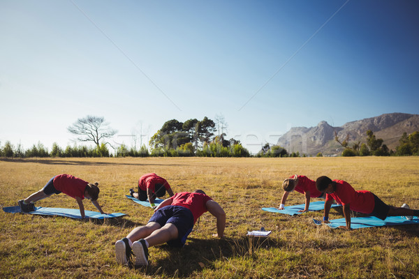 Trainer instructing kids while exercising in the boot camp Stock photo © wavebreak_media