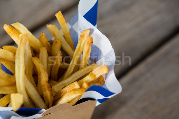 Close up of French fries with wax paper in container Stock photo © wavebreak_media