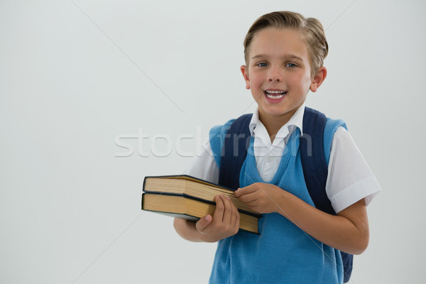 Portré boldog iskolás fiú tart könyvek fehér Stock fotó © wavebreak_media