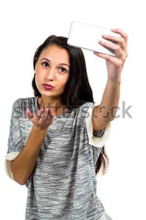 Smiling girl with hand cupped against white background Stock photo © wavebreak_media