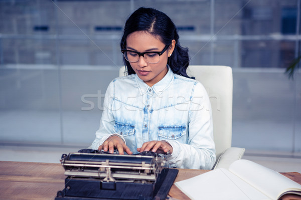 Stock photo: Asian woman typewriting